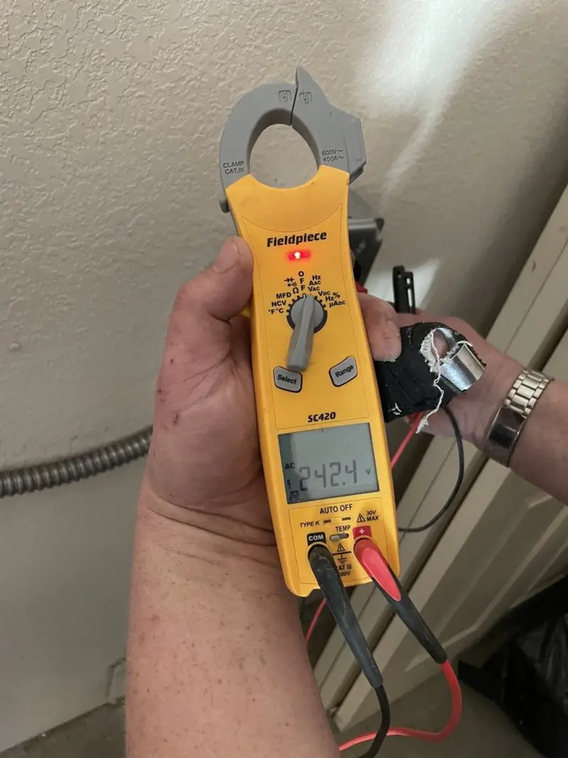 Voltage testing with clamp meter during Whole House Surge Protector in Walker